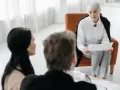 Pracownik socjalny omawia dokumenty z parą.