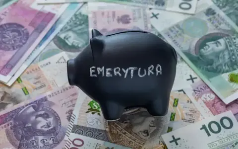 Czarna skarbonka z napisem "EMERYTURA" na tle polskich banknotów. Zastanawiasz się, jaka emerytura przy zarobkach 7000 brutto?